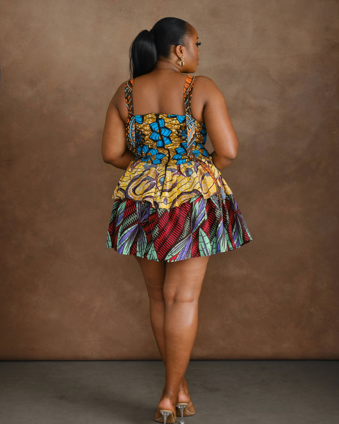 Back view of a woman wearing a vibrant ankara mini dress