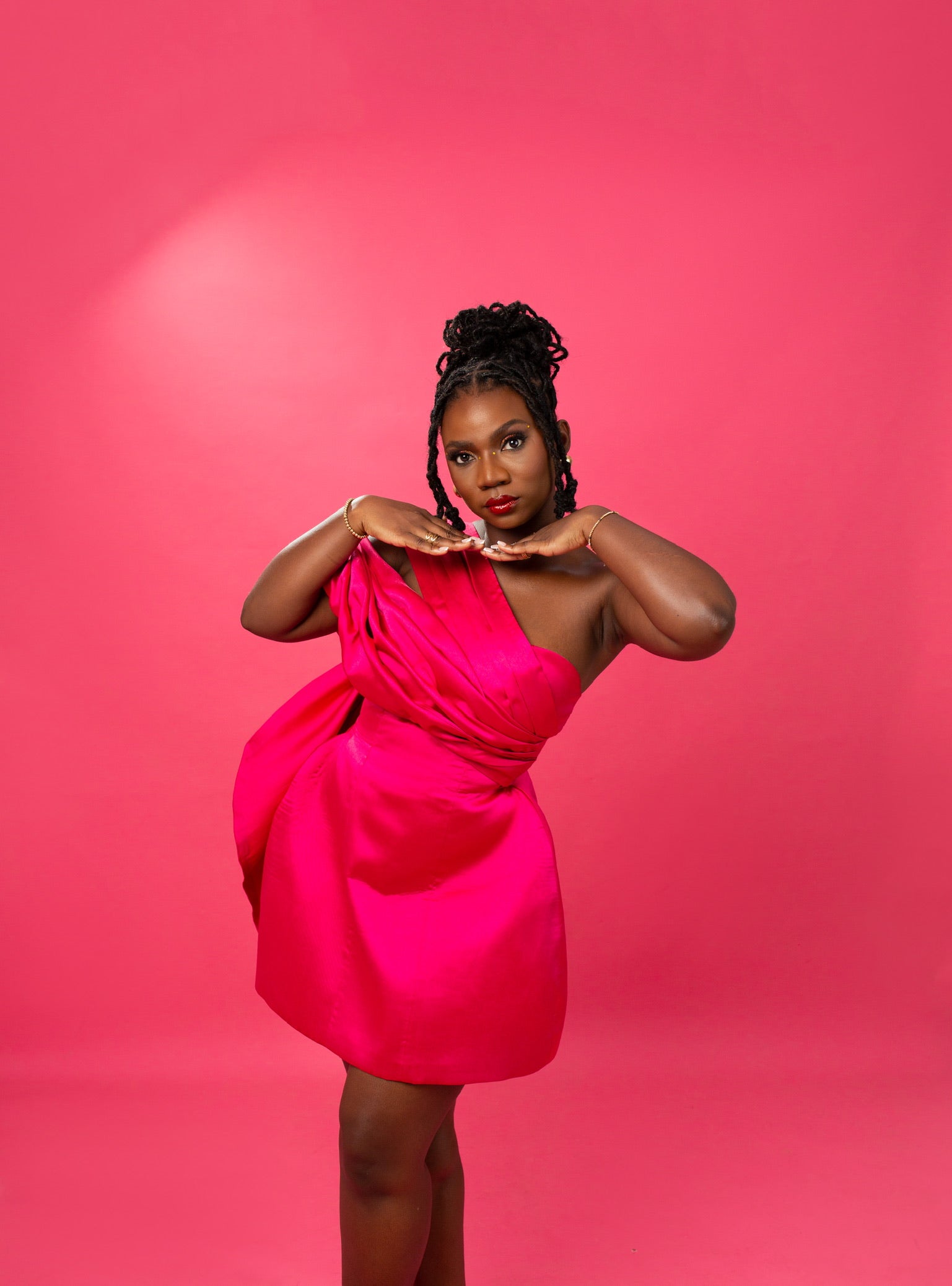 Chic woman gracefully adorned in a stunning pink dress from our latest collection.